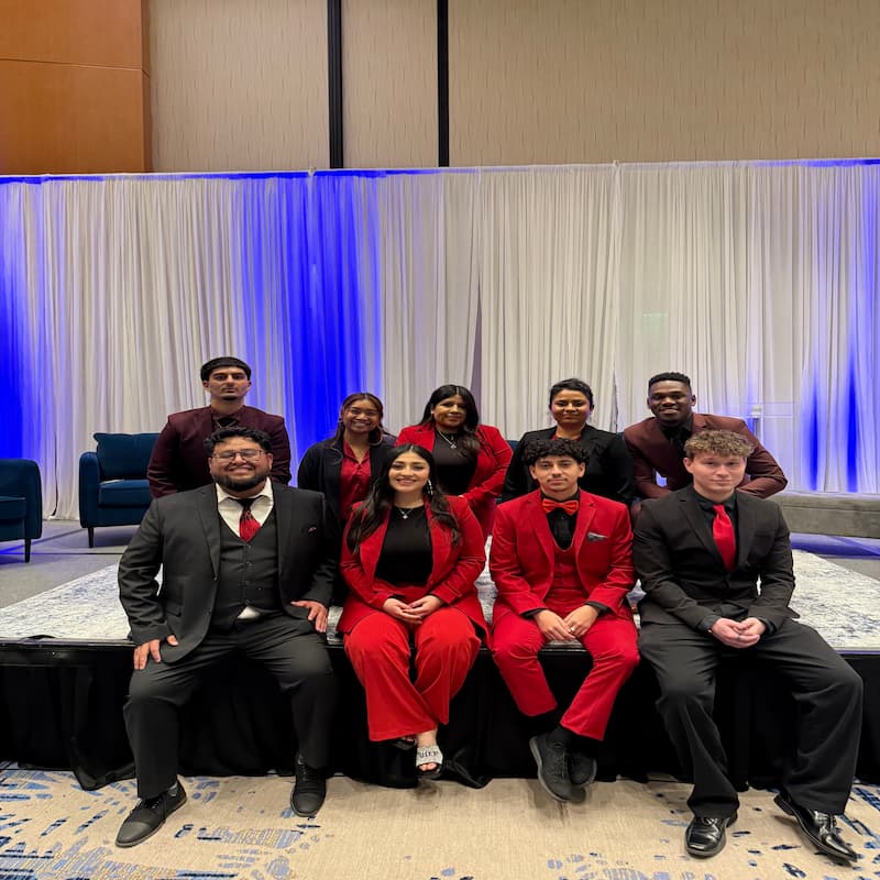 Legends Ascend Inc team at annual conference wearing red and black company colors